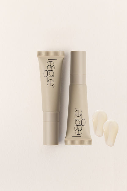 Two beige cosmetic tubes and clear product swatches with 'League' branding on a light background