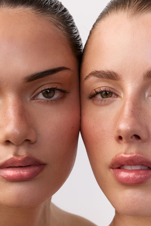 Two women with similar skin tones and features on a plain background